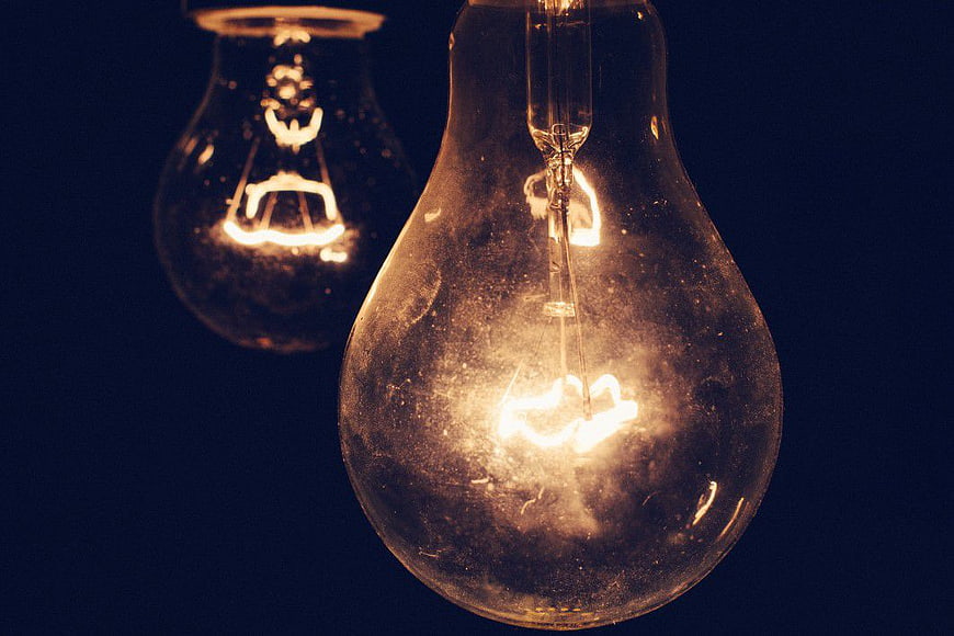 Vintage Light Bulb Glowing Against Dark Background