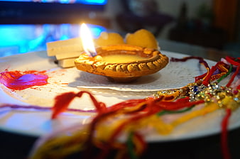 Traditional Rakhi Festival Setup with Diya and Sacred Thread