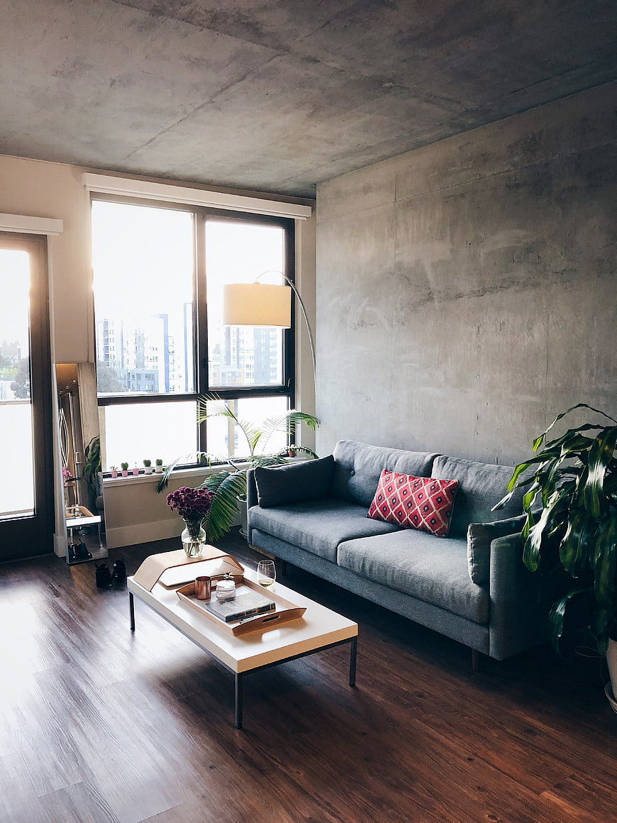 Modern Loft Living Room with Concrete Walls and Gray Sofa