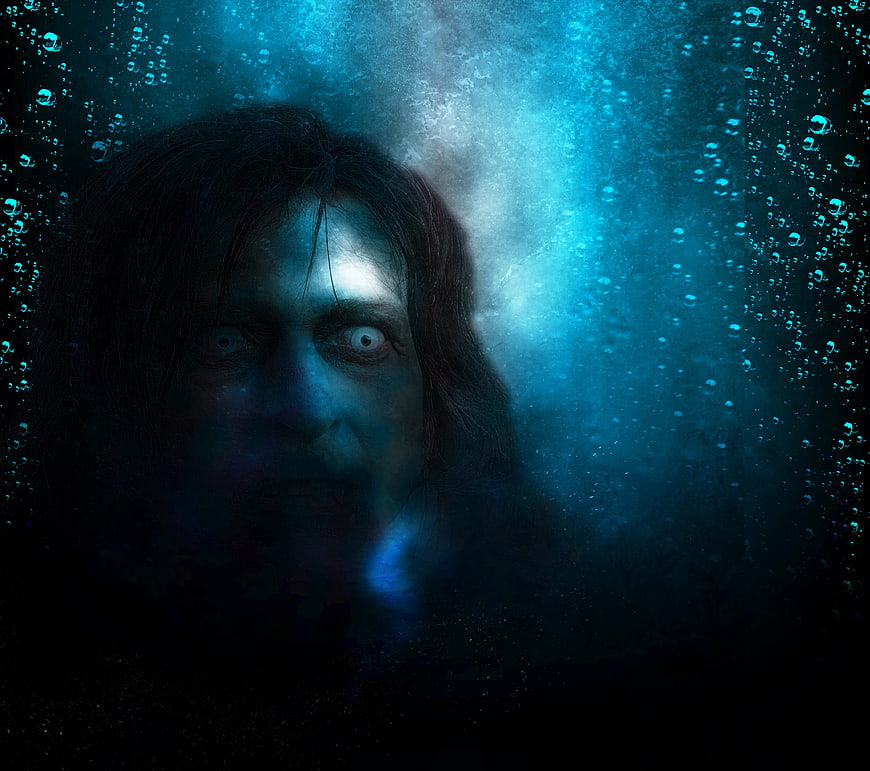Scary ghost face underwater with bubbles and blue light