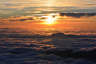Golden Sunset Over Sea of Clouds with Mountain Peaks