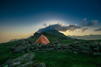 Orange Tent on Rocky Mountain Ridge at Sunset