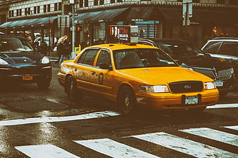Yellow NYC Taxi on Wet City Street