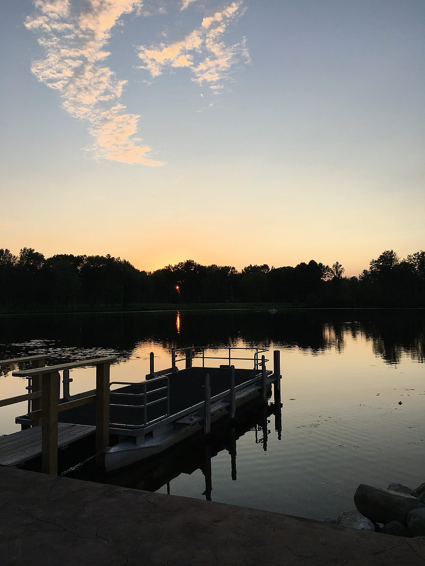 Serene Lake Sunset with Dock and Reflection