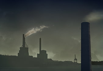 Silhouette of Industrial Factory Smokestacks Emitting Smoke