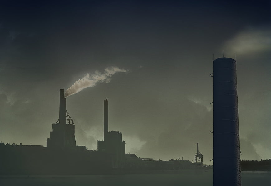 Silhouette of Industrial Factory Smokestacks Emitting Smoke
