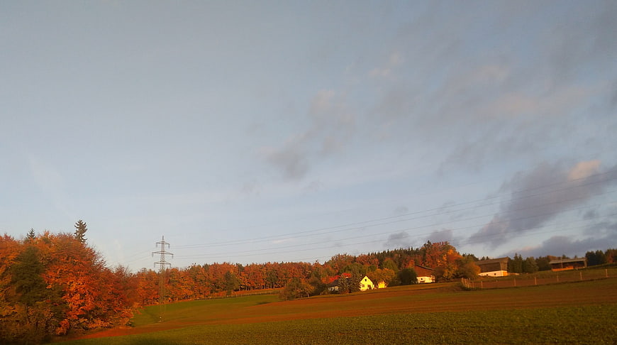 Serene Autumn Landscape with Golden Sunrise and Rolling Hills
