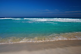 Tropical Beach Landscape With Turquoise Ocean Water And Sandy Shore