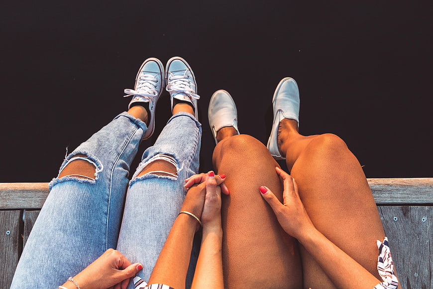Top View of Couple Holding Hands on Wooden Bench