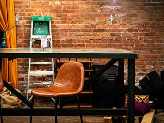 Industrial Workspace with Leather Chair and Brick Wall
