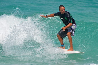 Man surfing on turquoise ocean wave