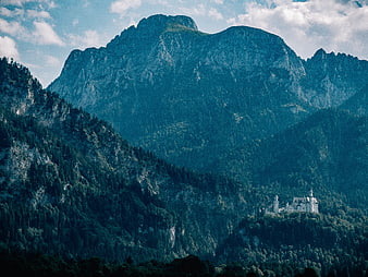 Neuschwanstein Castle nestled in Bavarian Alps mountains