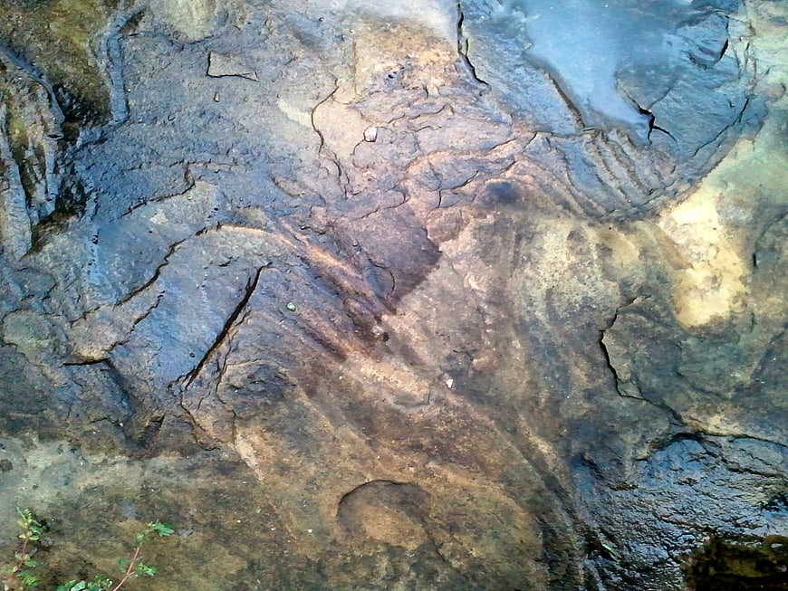 Wet Rock Texture with Water Reflections and Natural Erosion