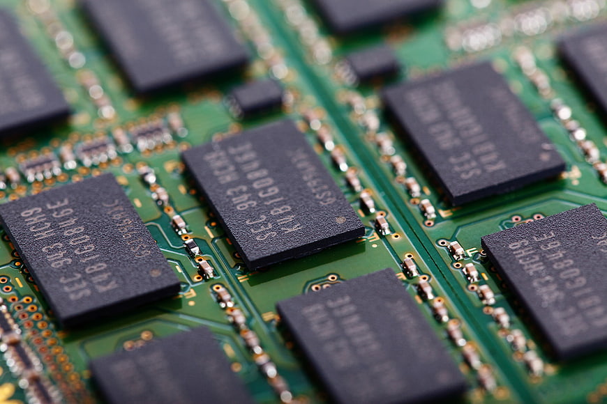 Macro Close-Up of Green Circuit Board with Black RAM Chips