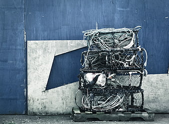 Stack of lobster traps against blue wooden wall