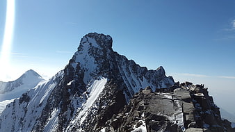 Snow-Capped Mountain Peak Against Blue Sky