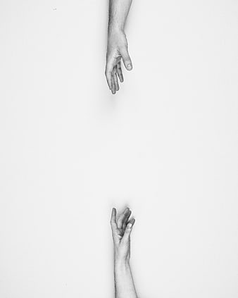 Black and white hands reaching towards each other with distance