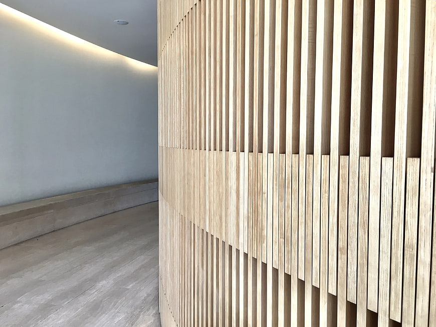 Modern curved wooden slat wall interior design