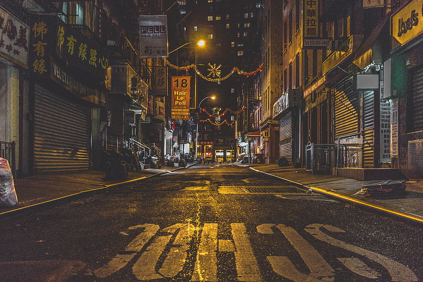 Empty Chinatown Street at Night with Wet Pavement
