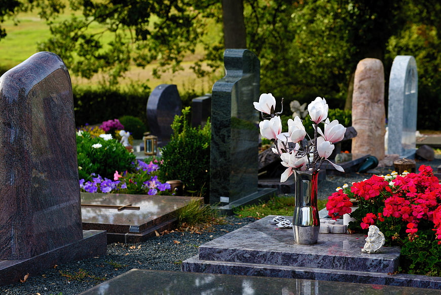 Graveyard Scene With White Flowers And Colorful Tombstones