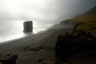 Misty Black Sand Beach with Sea Stack and Lone Walker