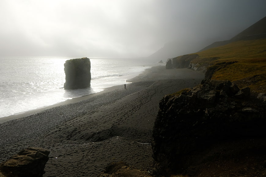 Misty Black Sand Beach with Sea Stack and Lone Walker