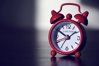 Red Vintage Alarm Clock on Dark Surface