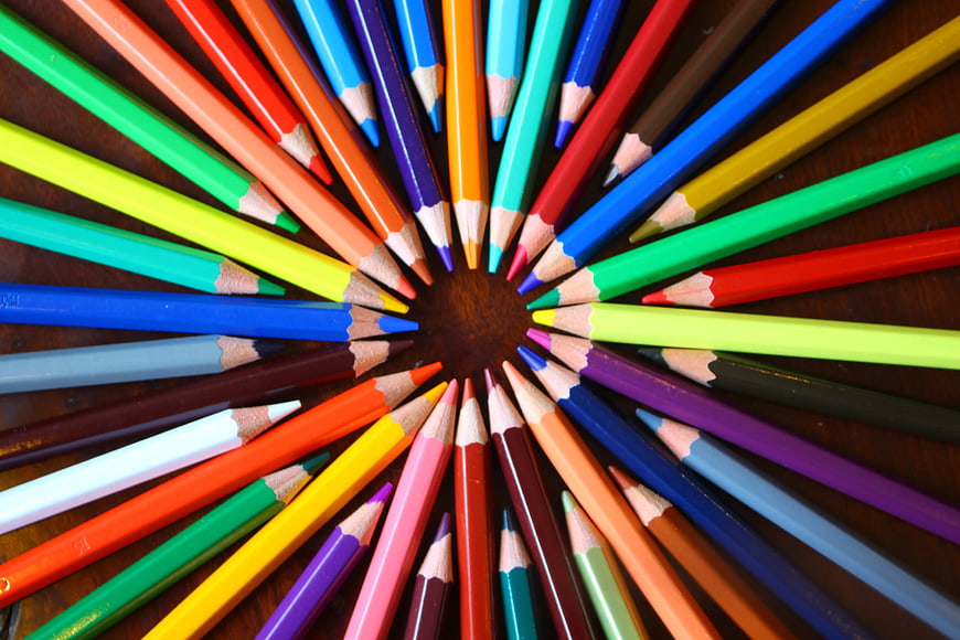 Colorful Pencils Arranged in a Circle on Wood