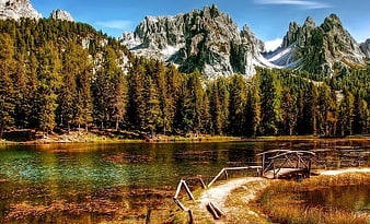 Scenic Wooden Bridge Over Mountain Lake with Forest