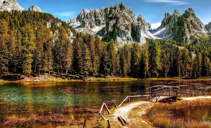 Scenic Wooden Bridge Over Mountain Lake with Forest