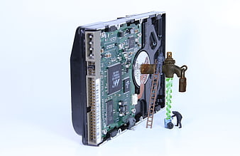 Conceptual Data Security Illustration with Hard Drive and Miniature Figures