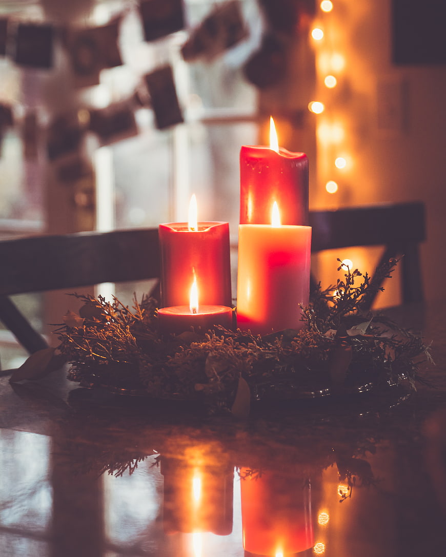Festive Advent Candles on Wooden Table with Warm Bokeh