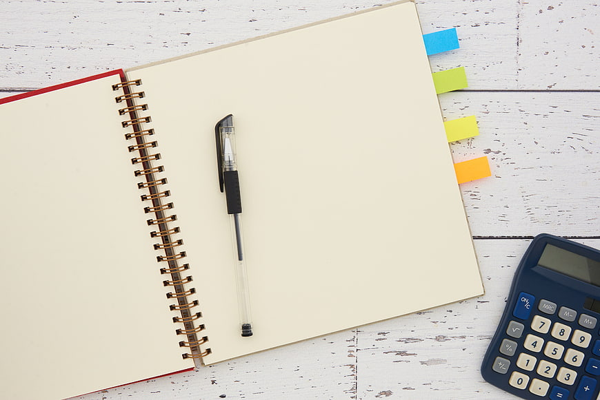 Blank Notebook, Pen, and Calculator on White Wooden Desk