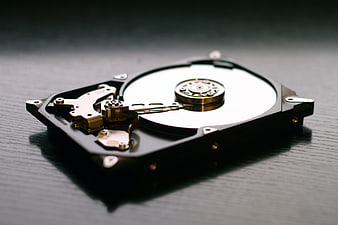Open Hard Drive Disk on Dark Wooden Surface