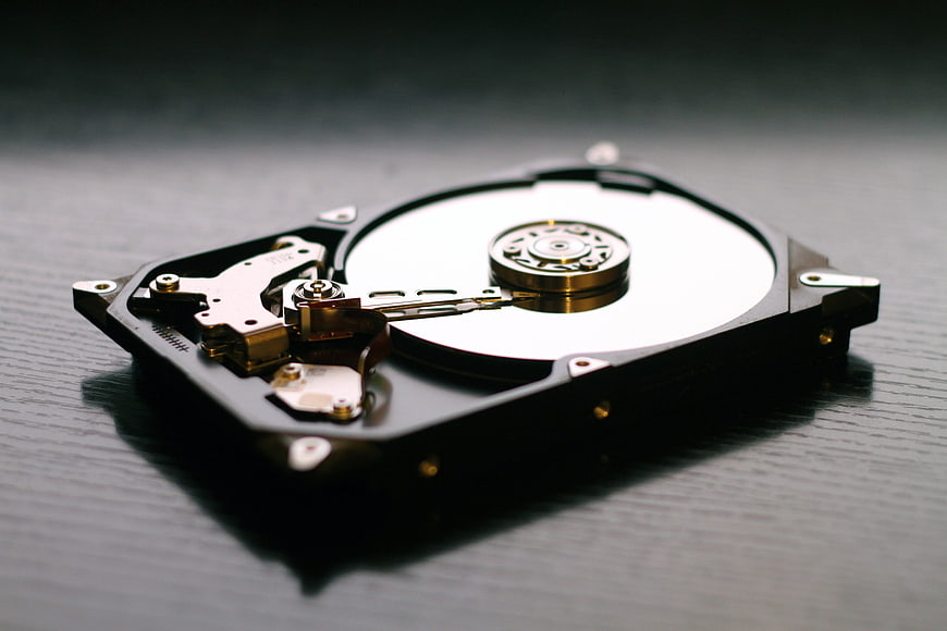 Open Hard Drive Disk on Dark Wooden Surface