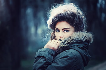Stylish Woman Portrait With Fur Hood In Moody Forest