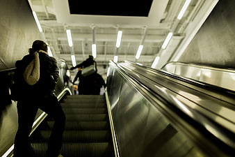 Low angle view of commuters on a subway escalator