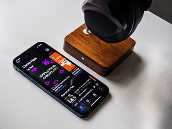 Smartphone with Podcast App and Headphones on Desk