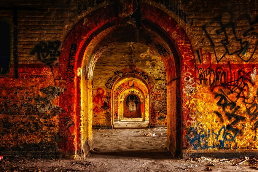 Abandoned Underground Corridor With Arched Vaults And Graffiti