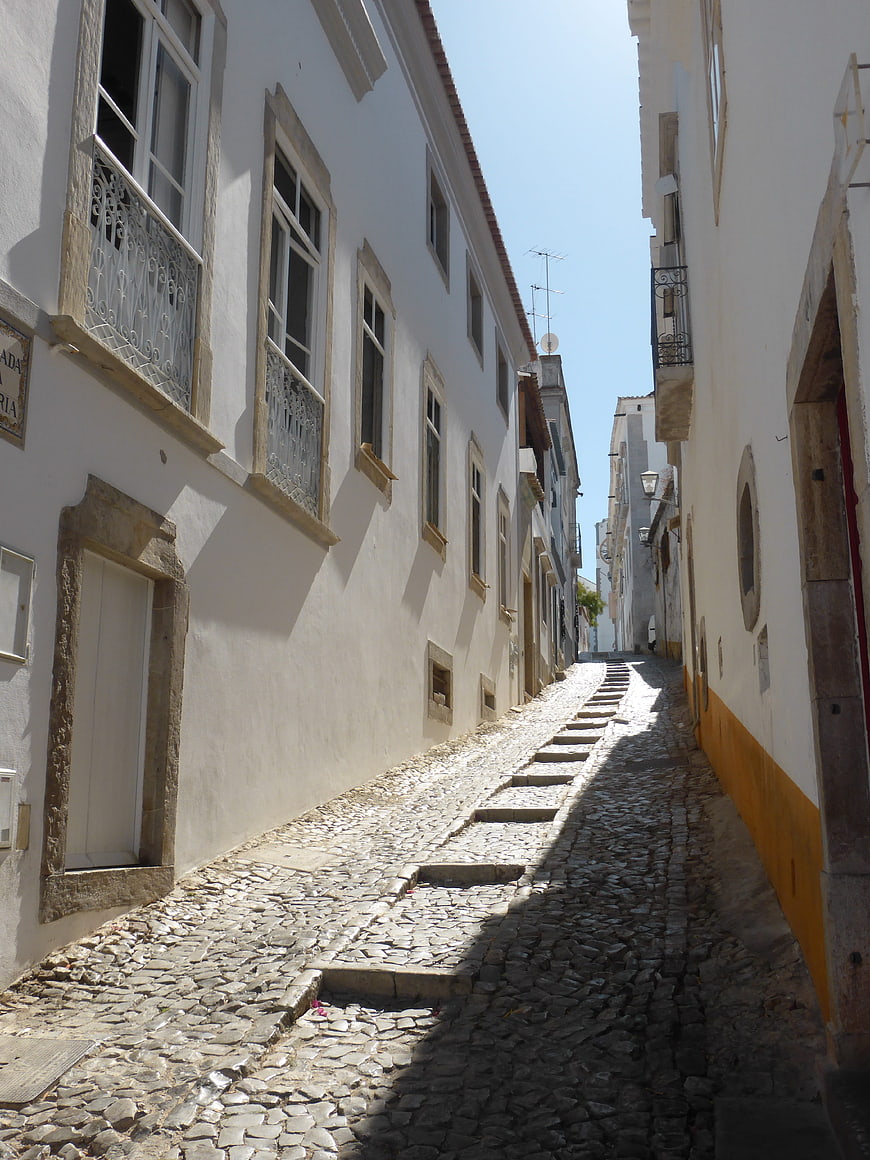 Narrow cobblestone street in white Portuguese village