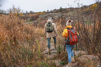 Couple Hiking on Trail in Autumn Landscape