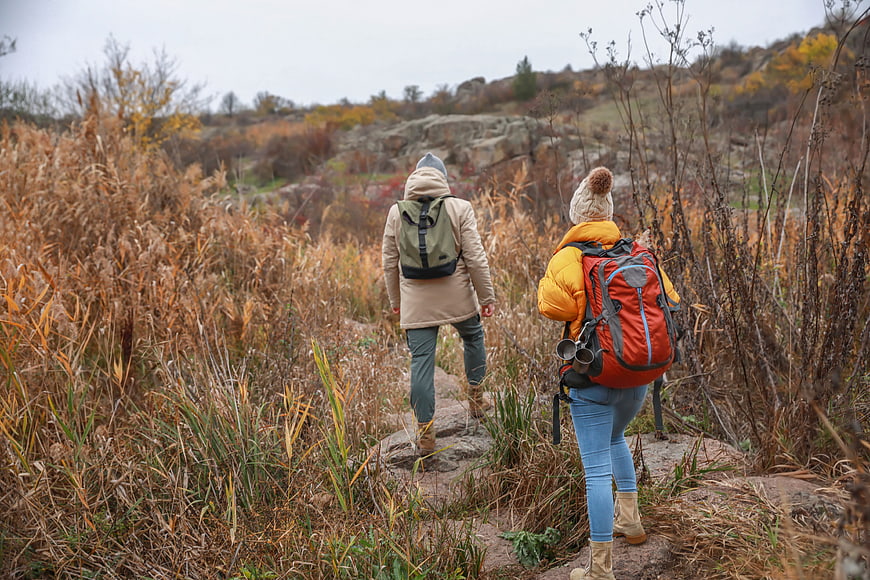 Couple Hiking on Trail in Autumn Landscape