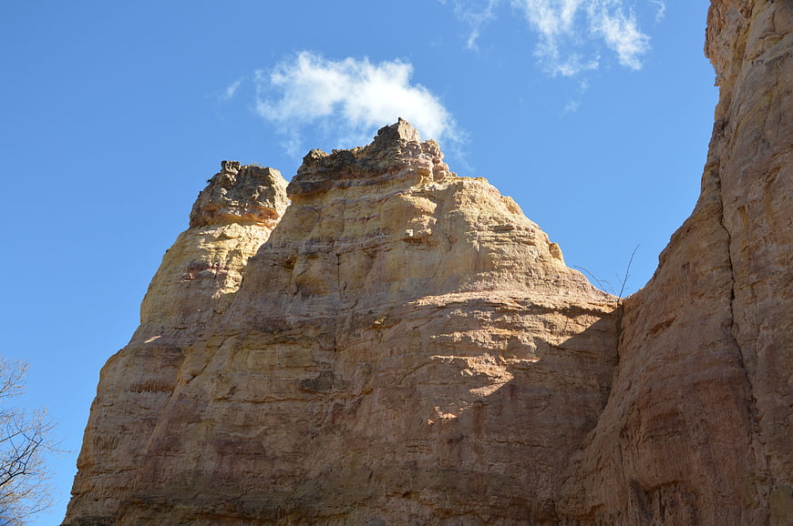 Towering Sandstone Rock Formation Against Blue Sky