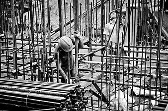 Construction workers installing rebar at a building site