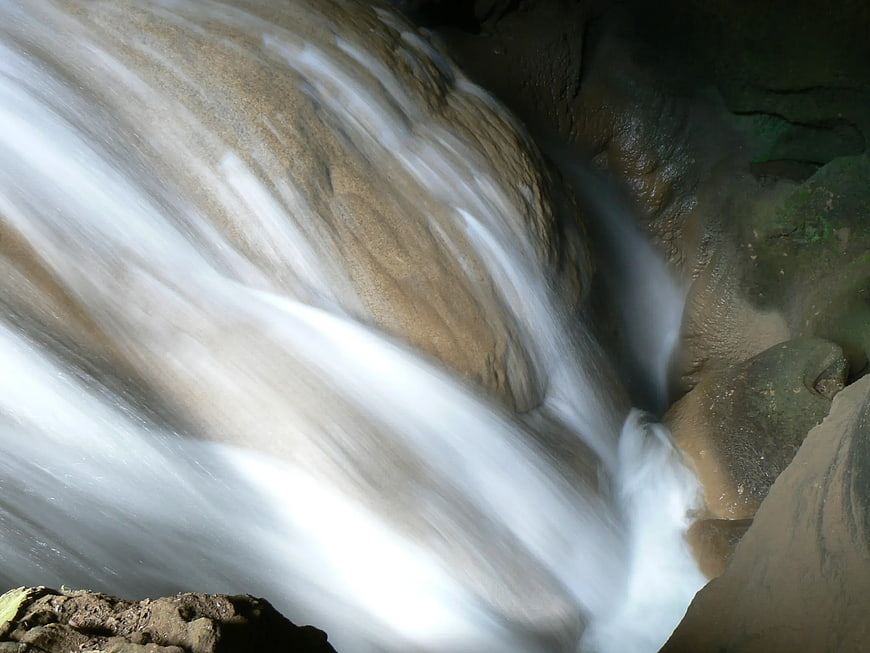 Long Exposure Waterfall Flowing Over Smooth Brown Rocks