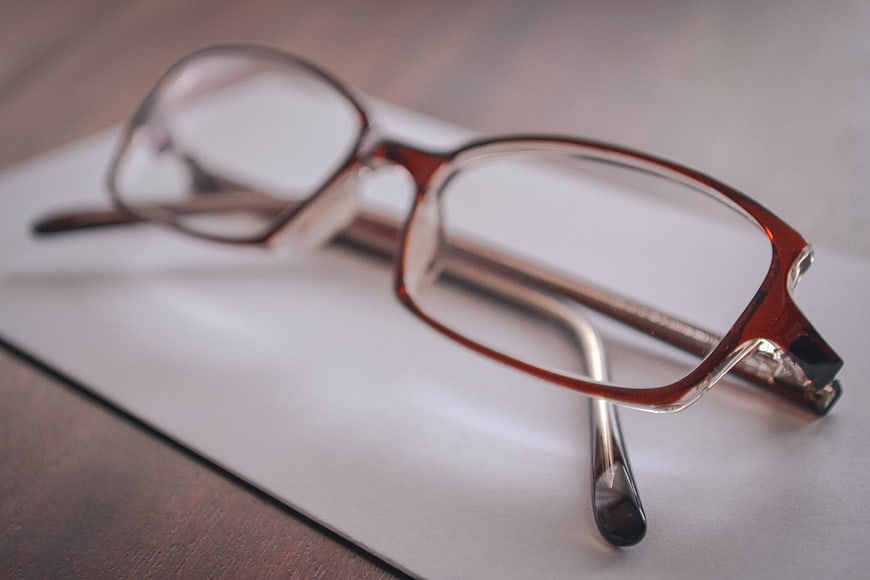Brown Eyeglasses on White Paper