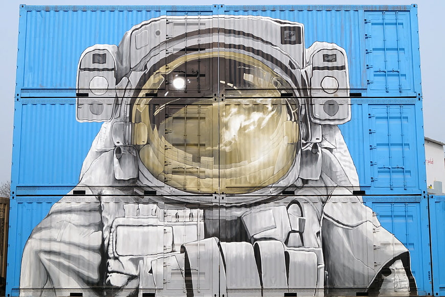 Astronaut Graffiti Mural on Blue Shipping Containers
