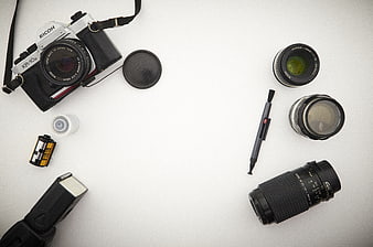 Vintage film camera gear flat lay on white background