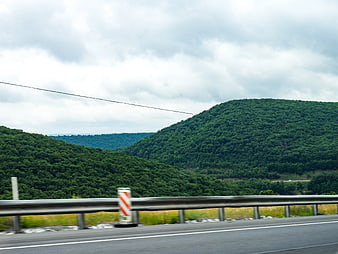 Green Forested Hills Viewed from Moving Highway