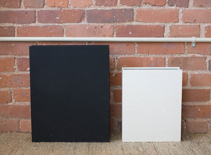 Black and White Blank Book Mockups on Brick Wall